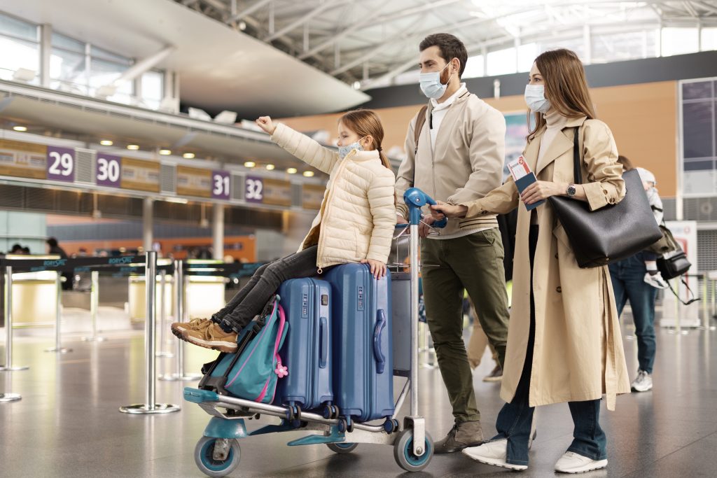 family coming out of airport looking for british car transfer