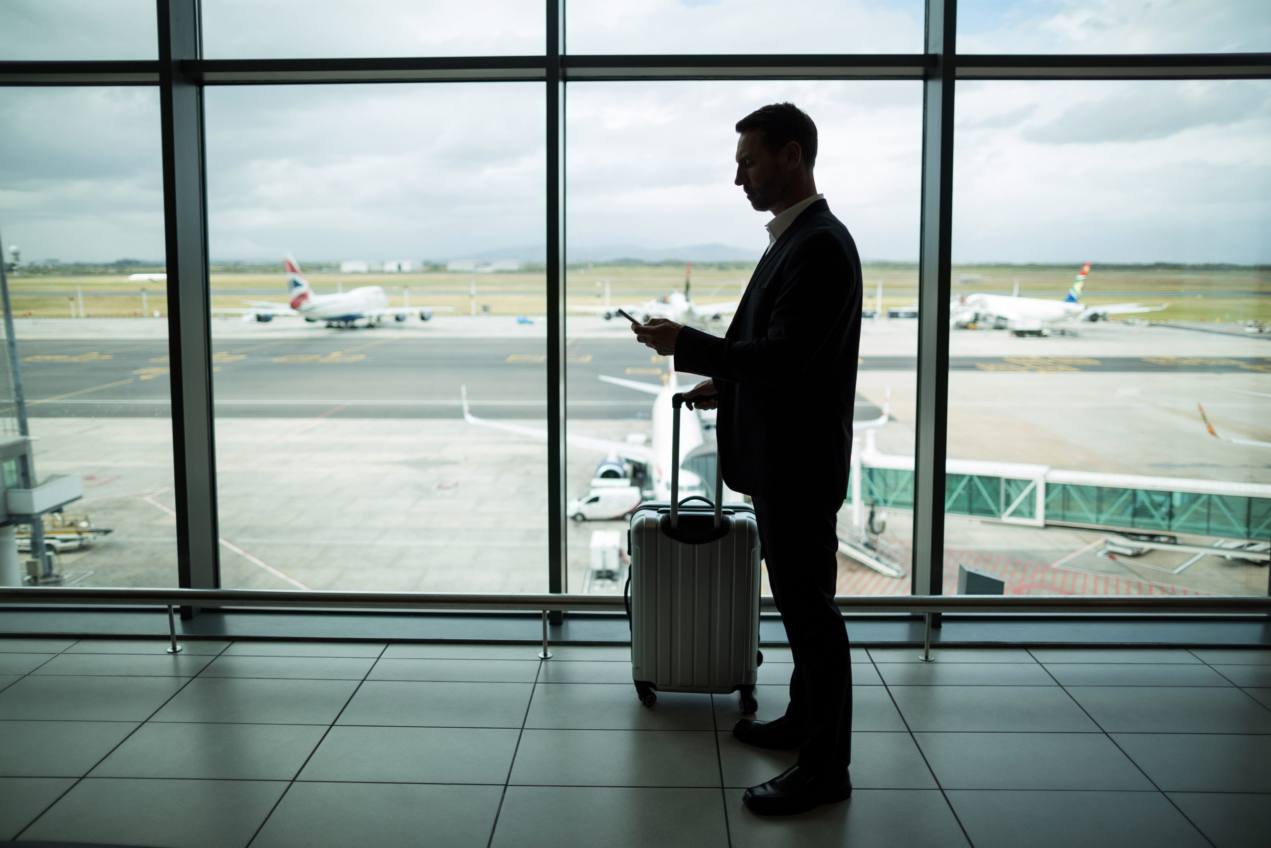 men at airport waiting for british car transfer taxi gatwick airport to haywards heath