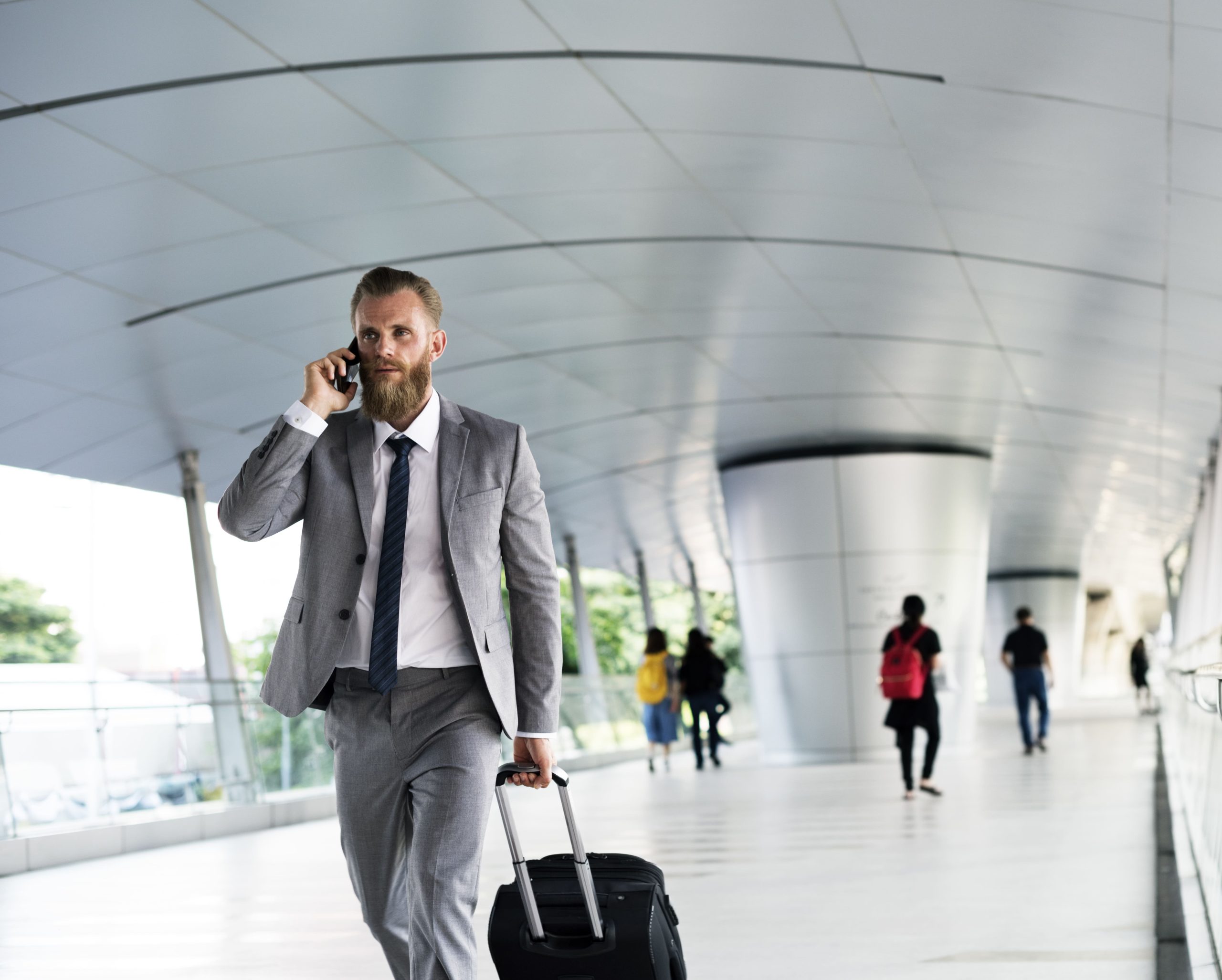 men walking in airport looking for british car transfer