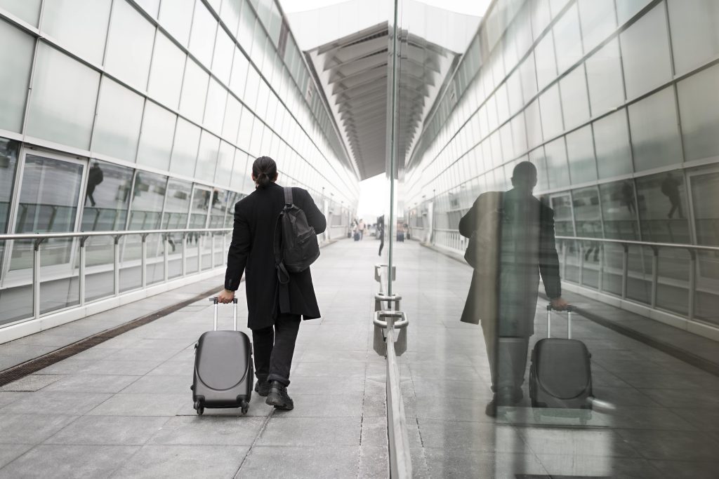 men coming out of airport towards british car transfer Taxi from Gatwick to Tunbridge Wells