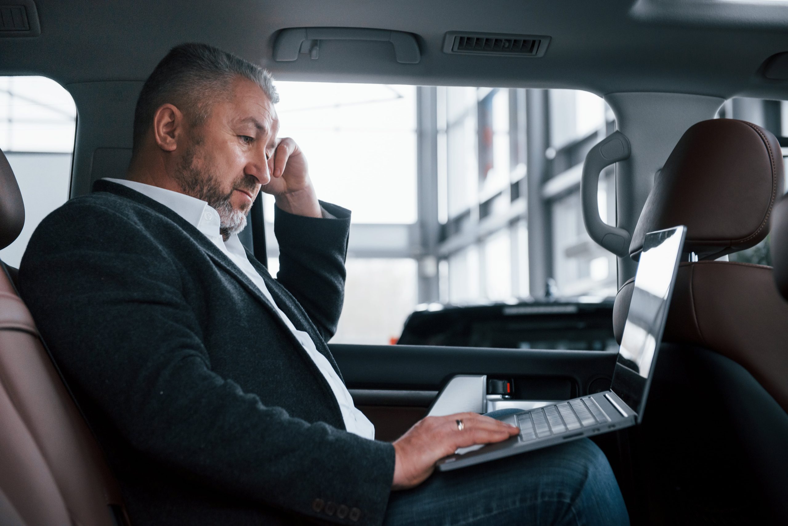 men sitting in british car transfer taxi